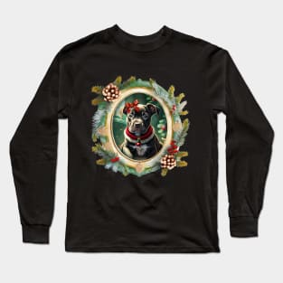 A cute black puppy dog wearing a festive bow and dog collar, in a winter Christmas picture frame with pinecones and winter berries Long Sleeve T-Shirt